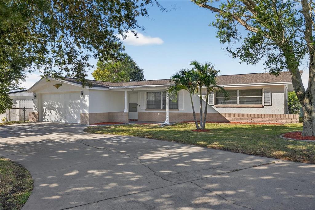 7421 Ashwood Drive Port Richey, FL 34668 - Photo 6 of 47 a view of a house with a yard and large tree
