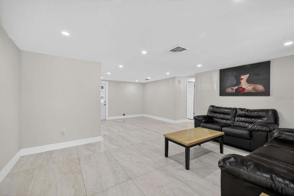 7421 Ashwood Drive Port Richey, FL 34668 - Photo 9 of 47 a living room with furniture and a flat screen tv