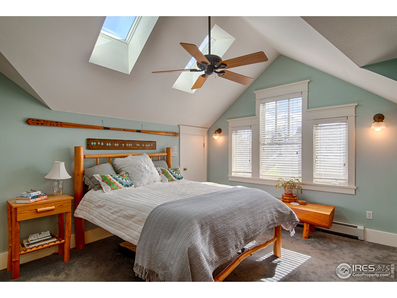 3182 7th Street Boulder, CO 80304 - Photo 19 of 38 a bedroom with a bed a chandelier and a window