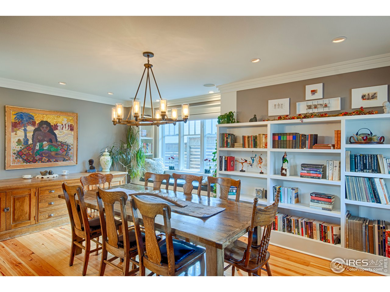 3182 7th Street Boulder, CO 80304 - Photo 5 of 38 a dining room with furniture a book shelves and wooden floor
