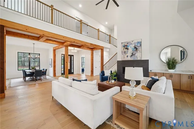 a living room with fireplace furniture and a large window