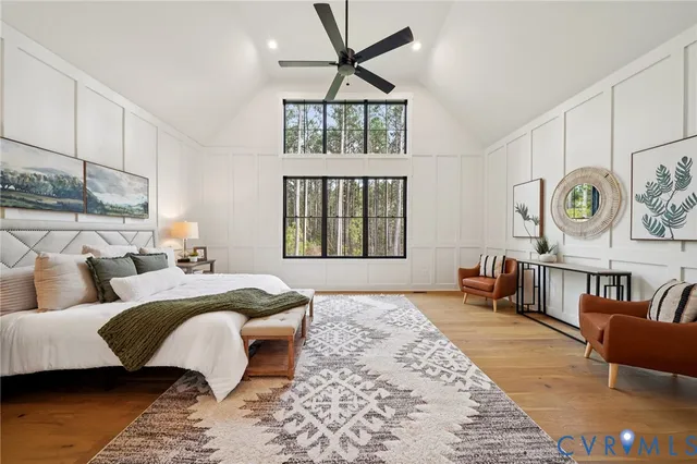 a bedroom with a bed couches and a window