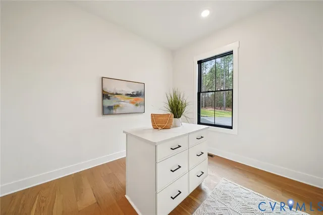 a view of cabinets with wooden floor and a window