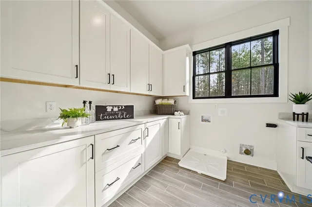a kitchen with stainless steel appliances white cabinets and a window