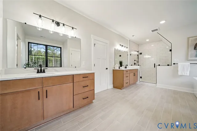 a spacious bathroom with a double vanity sink mirror and double