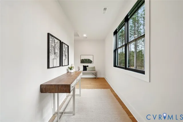 a view of hallway with furniture and a window