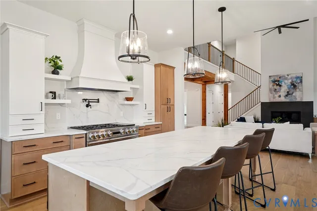 a kitchen with a table chairs and white cabinets