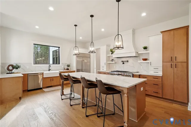 a kitchen with a table chairs sink and wooden floor