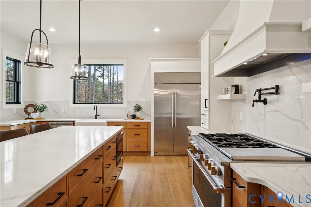 1165 Cardinal Crest Terrace Midlothian, VA 23113 - Photo 7 of 50 a kitchen with kitchen island a sink stove and wooden floor