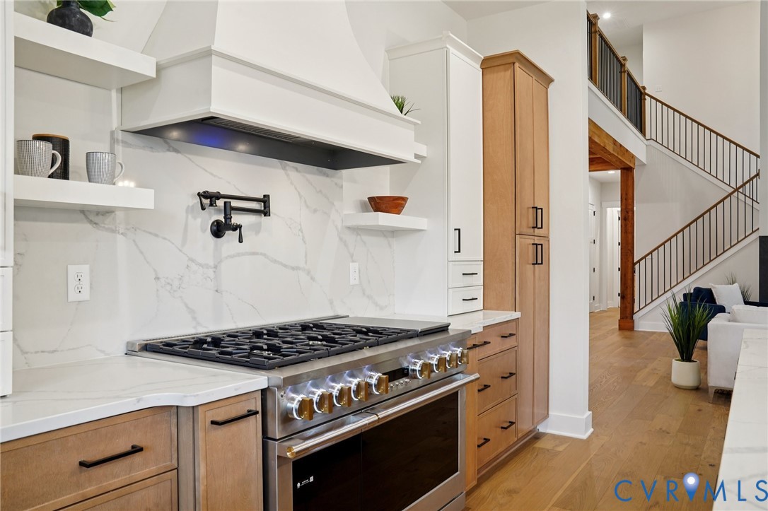 1165 Cardinal Crest Terrace Midlothian, VA 23113 - Photo 8 of 50 a kitchen with stainless steel appliances granite countertop a stove and a wooden floor