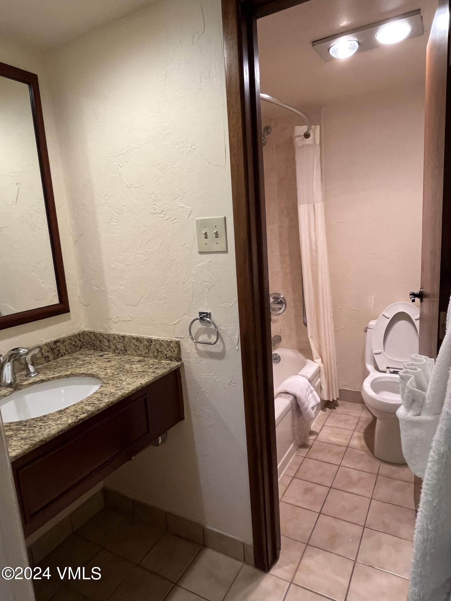1020 Vail View Drive, Unit 131232 Vail, CO 81657 - Photo 5 of 20 a bathroom with a sink and a mirror