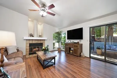 a living room with furniture fireplace and flat screen tv