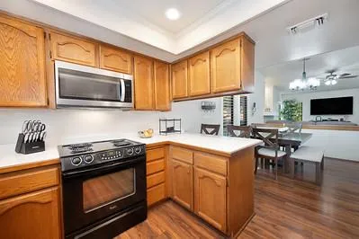a kitchen with a stove a sink and a microwave
