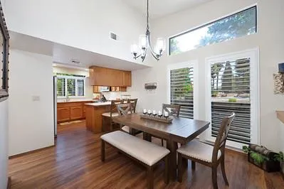 a workspace with furniture a chandelier and wooden floor