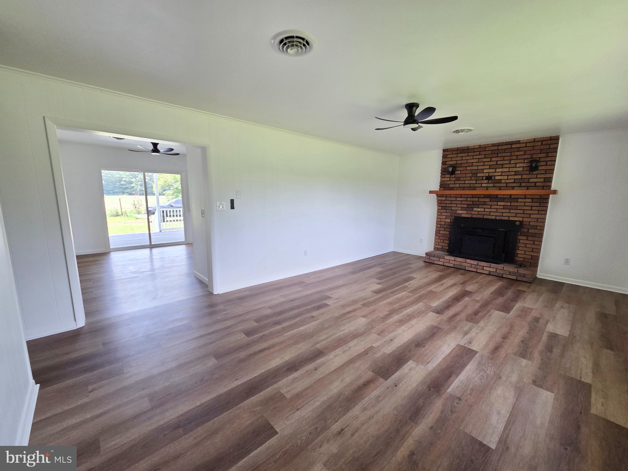 5046 Aireys Road Cambridge, MD 21613 - Photo 11 of 35 wooden floor fireplace and natural light in room