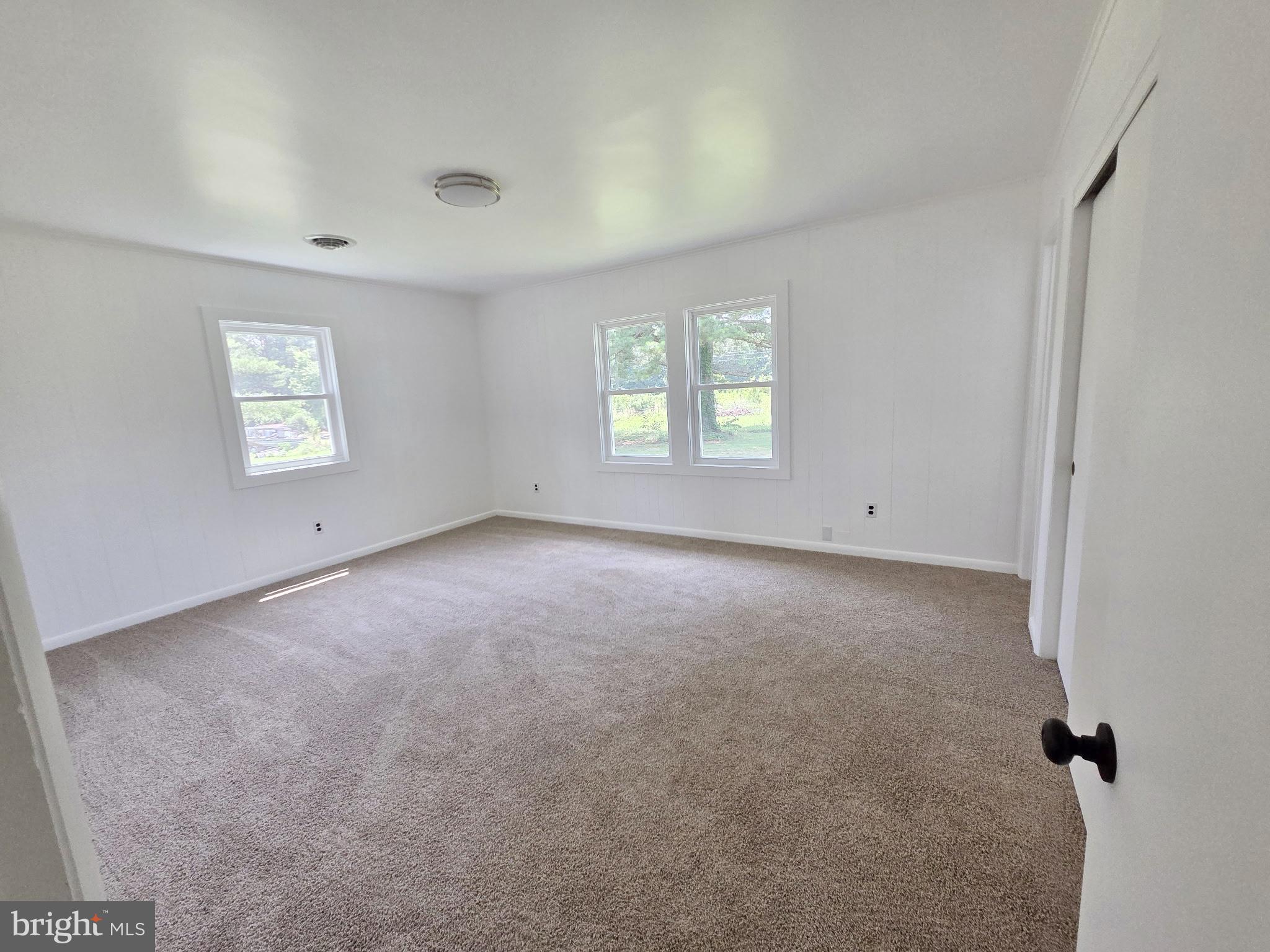 5046 Aireys Road Cambridge, MD 21613 - Photo 18 of 35 an empty room with windows and closet