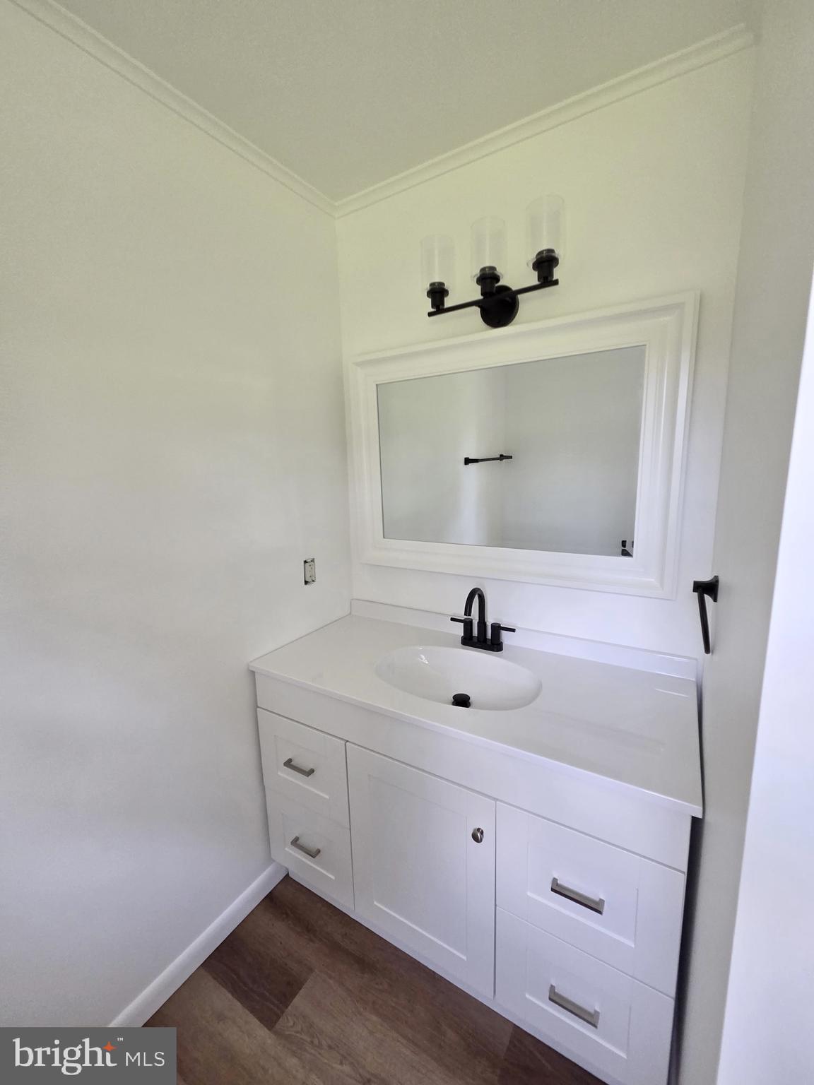 5046 Aireys Road Cambridge, MD 21613 - Photo 22 of 35 a bathroom with a sink and a mirror