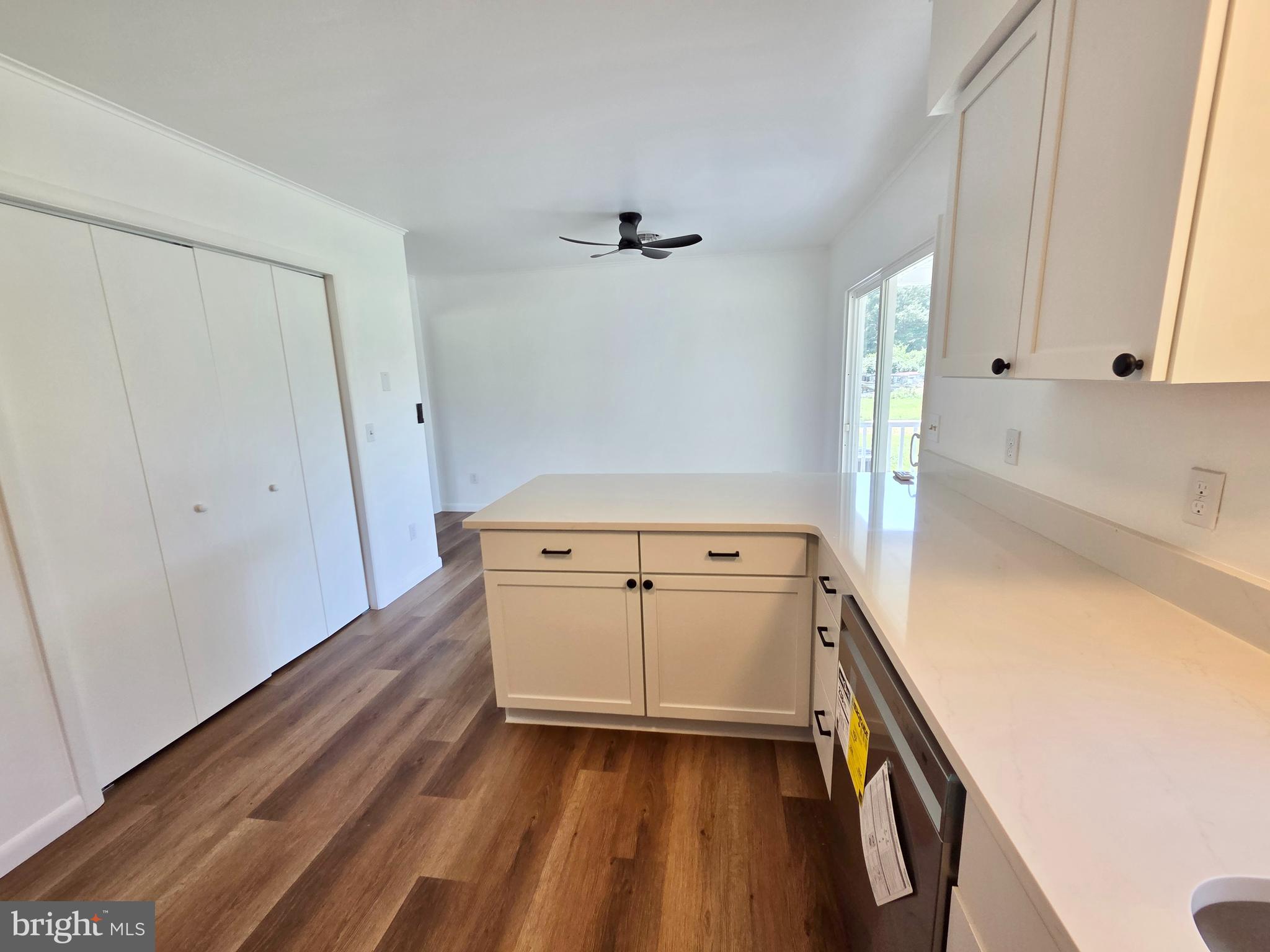 5046 Aireys Road Cambridge, MD 21613 - Photo 9 of 35 wooden floor in an empty room with a stove