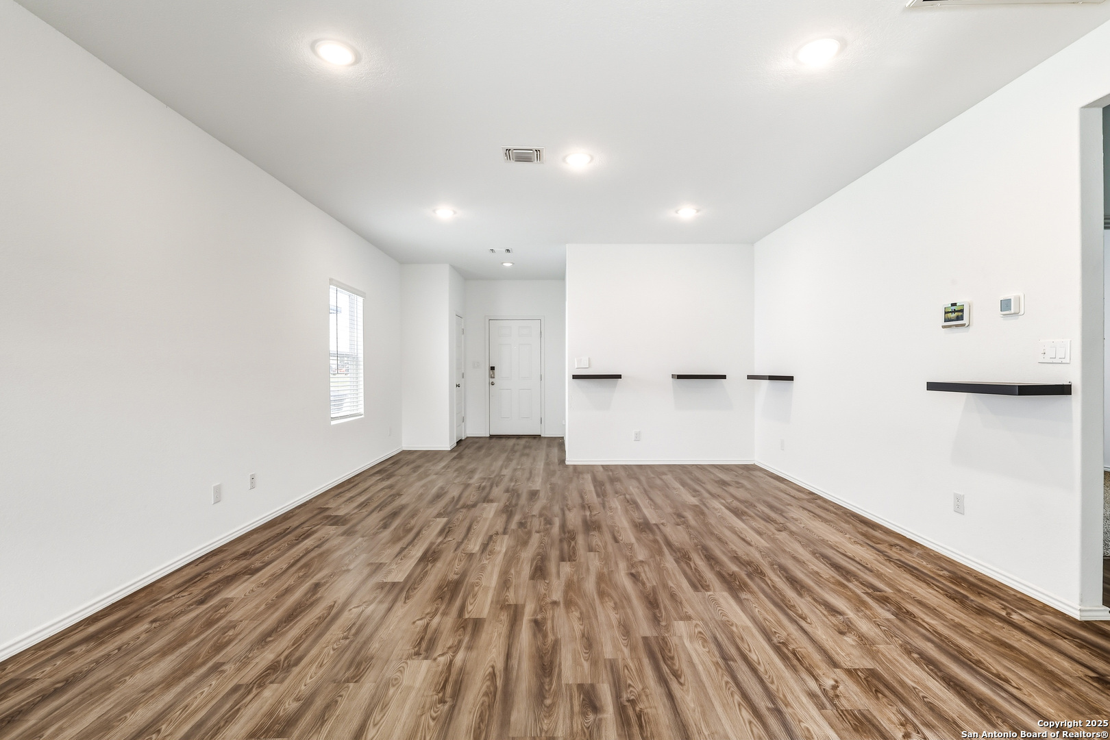 4426 Chandler Road, Unit 3 San Antonio, TX 78222 - Photo 2 of 26 a view of empty room with wooden floor and window