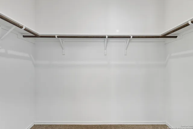 a view of a backyard with wooden fence