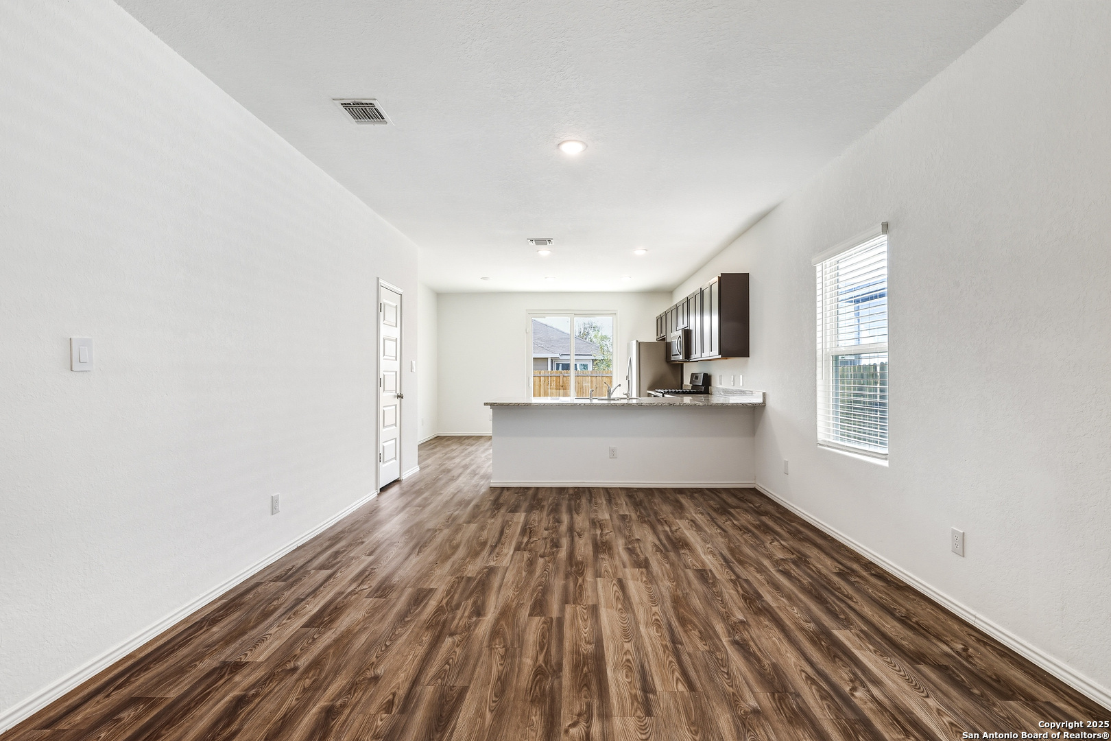 4426 Chandler Road, Unit 3 San Antonio, TX 78222 - Photo 6 of 26 a view of empty room with wooden floor and window