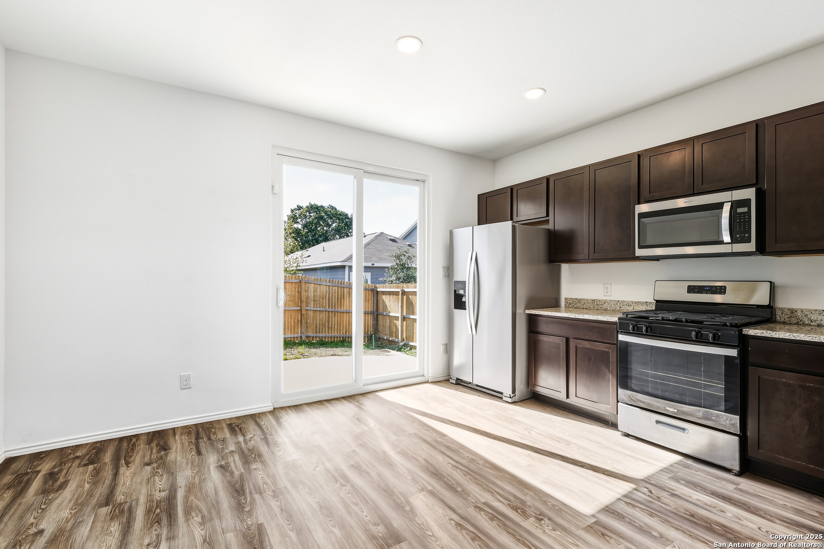 4426 Chandler Road, Unit 3 San Antonio, TX 78222 - Photo 9 of 26 a kitchen with stainless steel appliances a refrigerator and a stove top oven