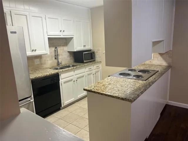 a kitchen with stainless steel appliances granite countertop a sink stove and cabinets