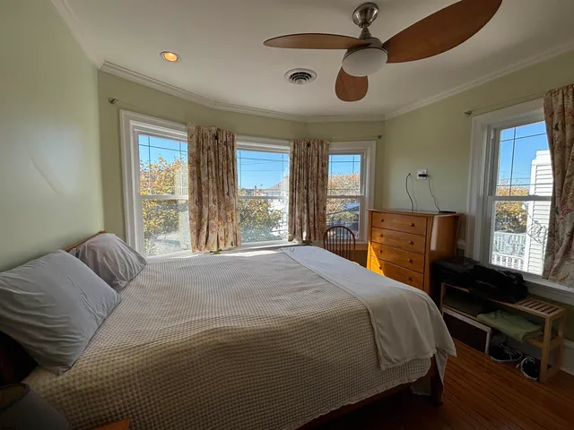 a bedroom with a large bed and a large window