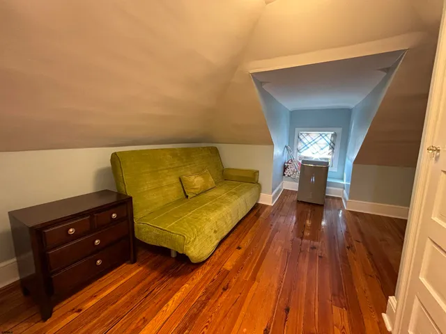 a spacious bedroom with a bed and a dresser