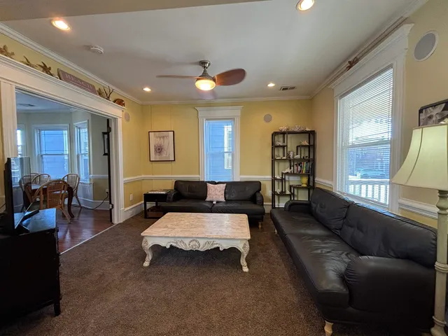 a spacious bedroom with a bed couch and a large mirror