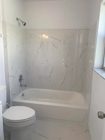 a bathroom with a bathtub and a toilet