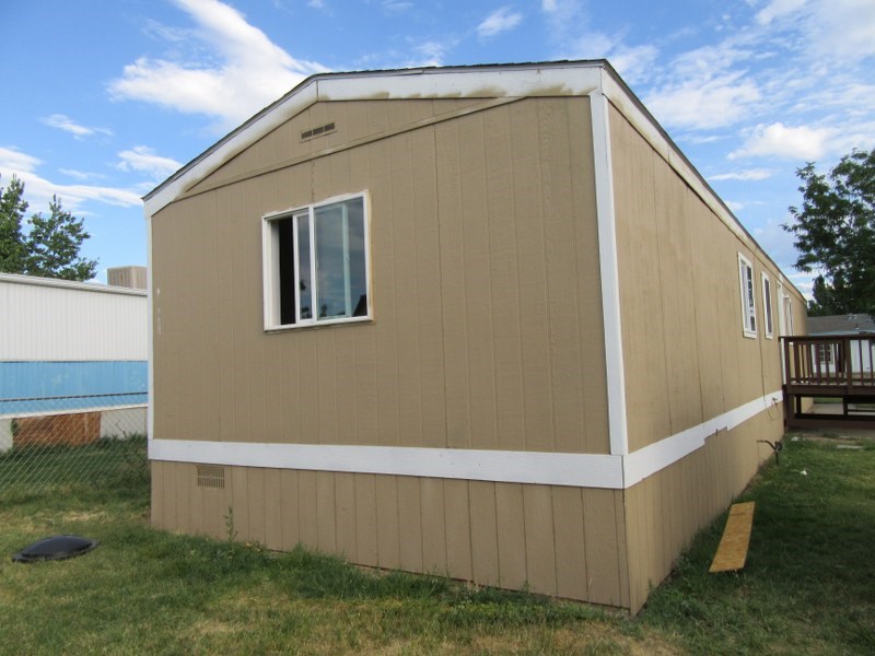 424 32 Road, Unit 413 Clifton, CO 81520 - Photo 7 of 13 a view of backyard with small cabin and wooden fence