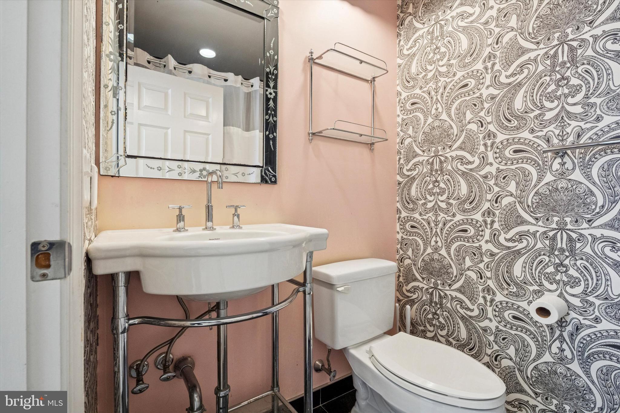 1600 Arch Street, Unit 2008 Philadelphia, PA 19103 - Photo 17 of 25 a bathroom with a sink toilet and mirror
