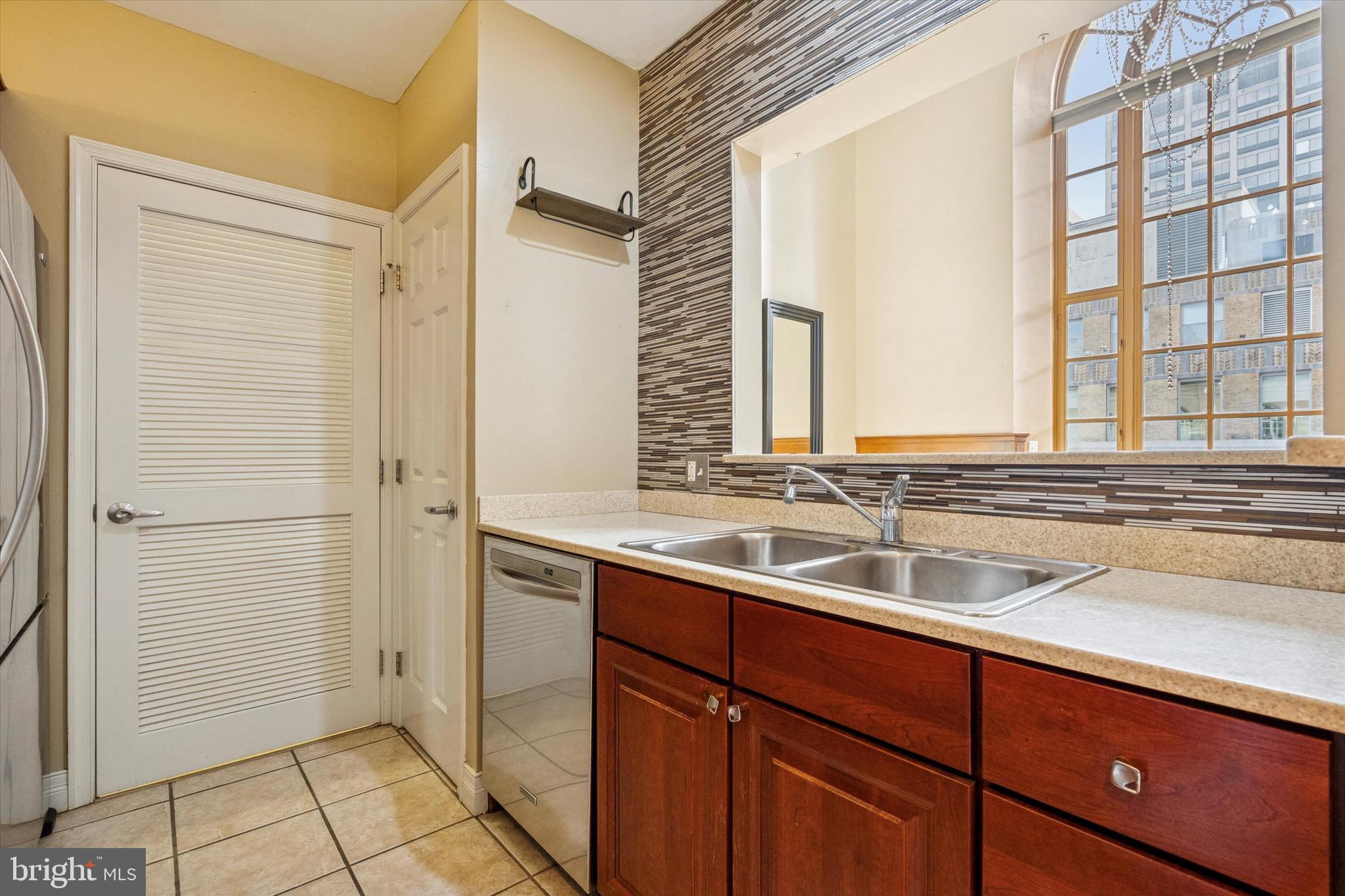 1600 Arch Street, Unit 2008 Philadelphia, PA 19103 - Photo 5 of 25 a bathroom with a sink and a mirror