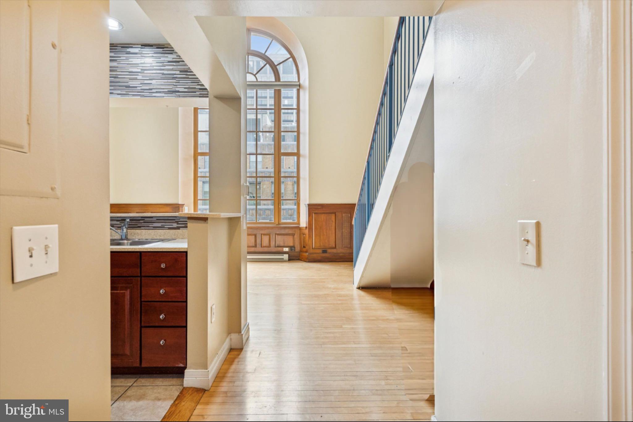 1600 Arch Street, Unit 2008 Philadelphia, PA 19103 - Photo 7 of 25 a view of hallway with stairs and wooden floor
