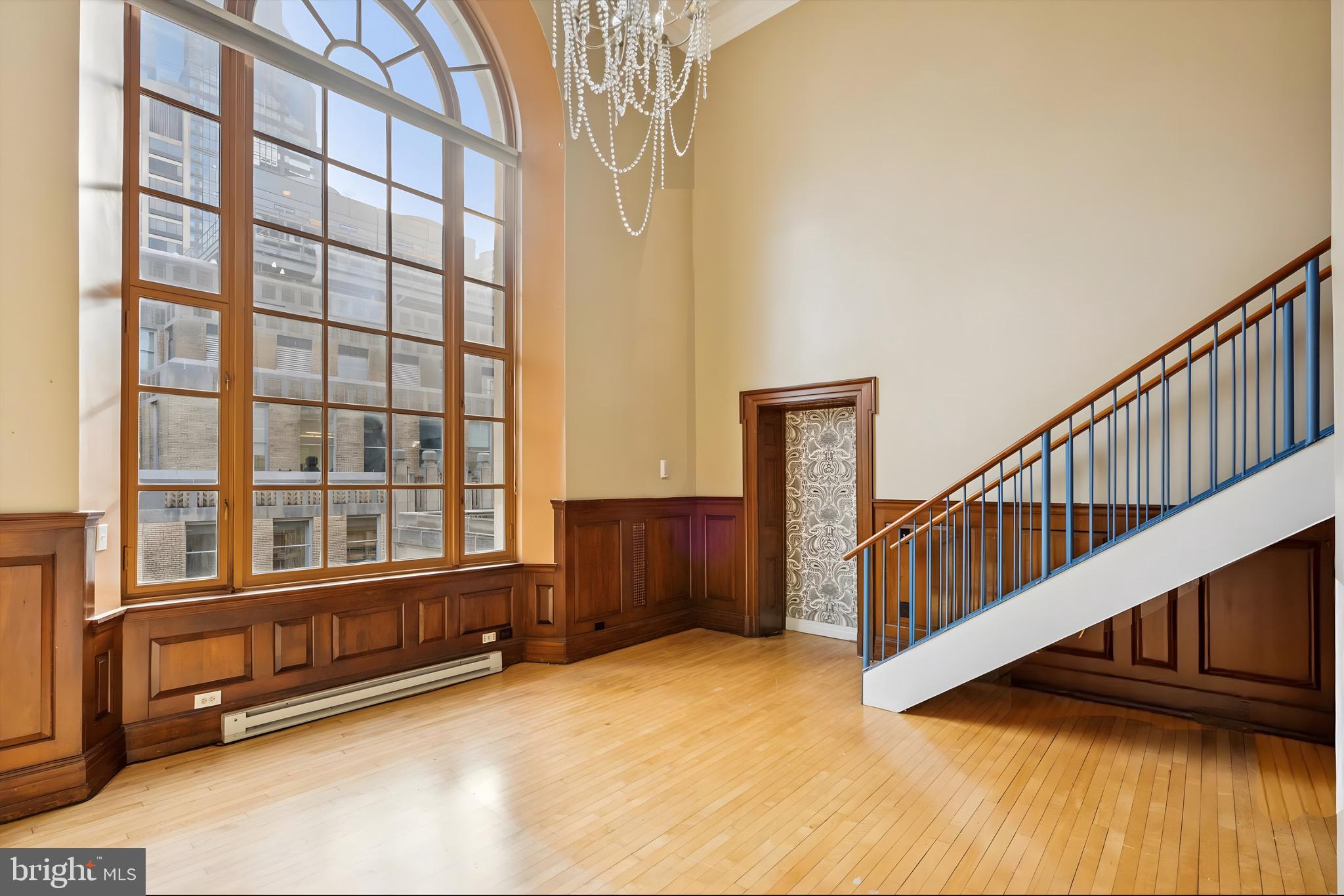 1600 Arch Street, Unit 2008 Philadelphia, PA 19103 - Photo 10 of 25 a view of an empty room with wooden floor and windows