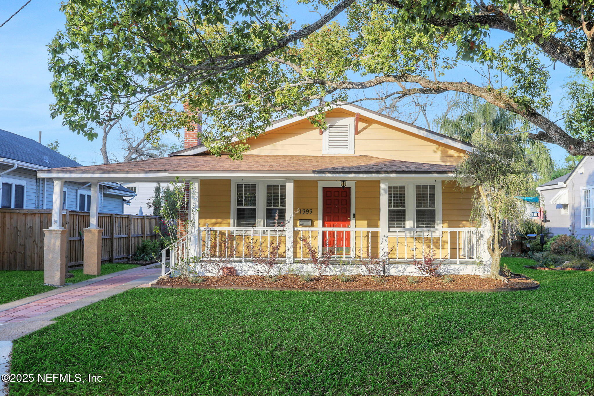 a front view of house with a garden and patio