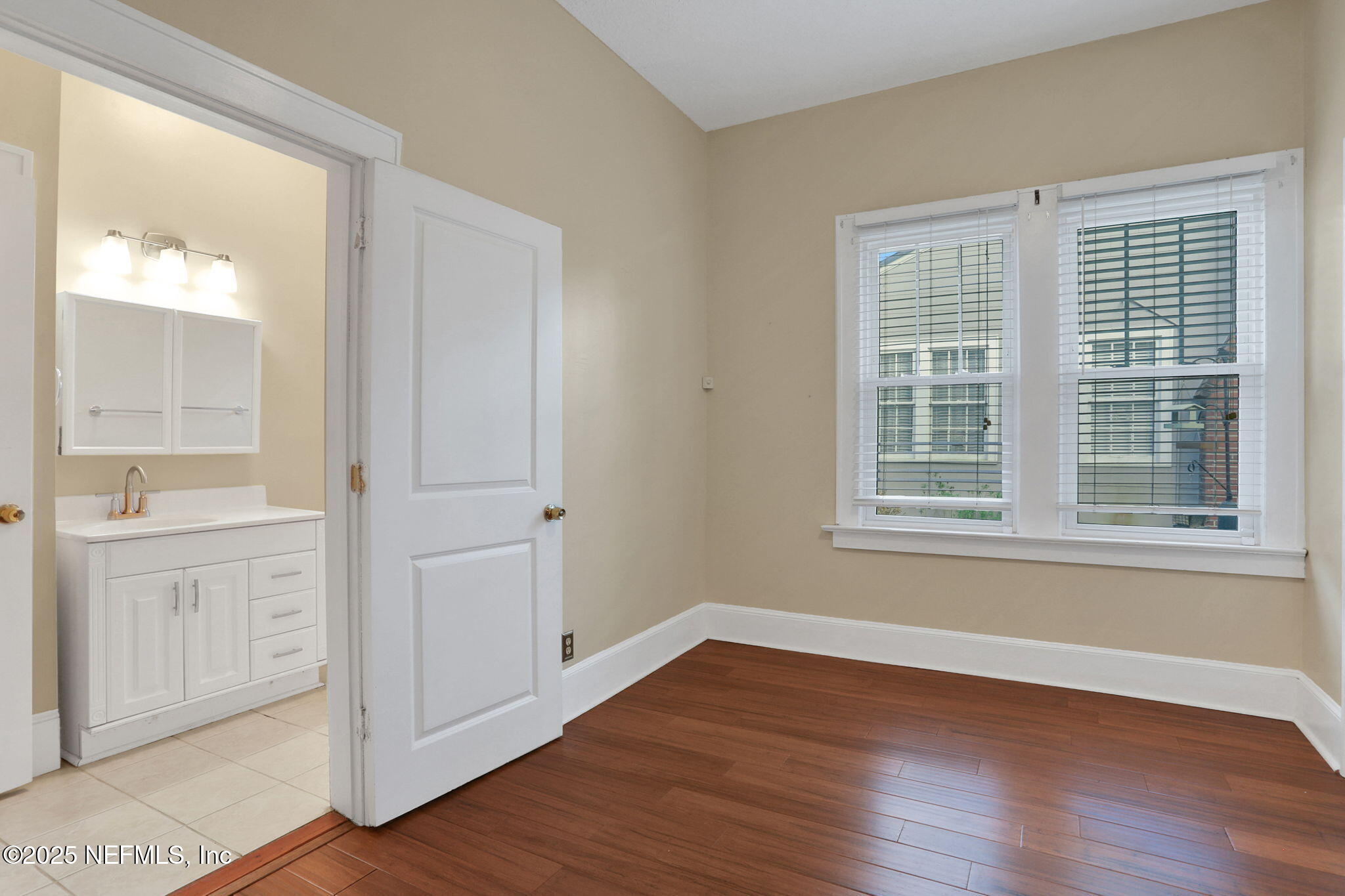 1393 Wolfe Street Jacksonville, FL 32205 - Photo 11 of 36 an empty room with wooden floor and windows