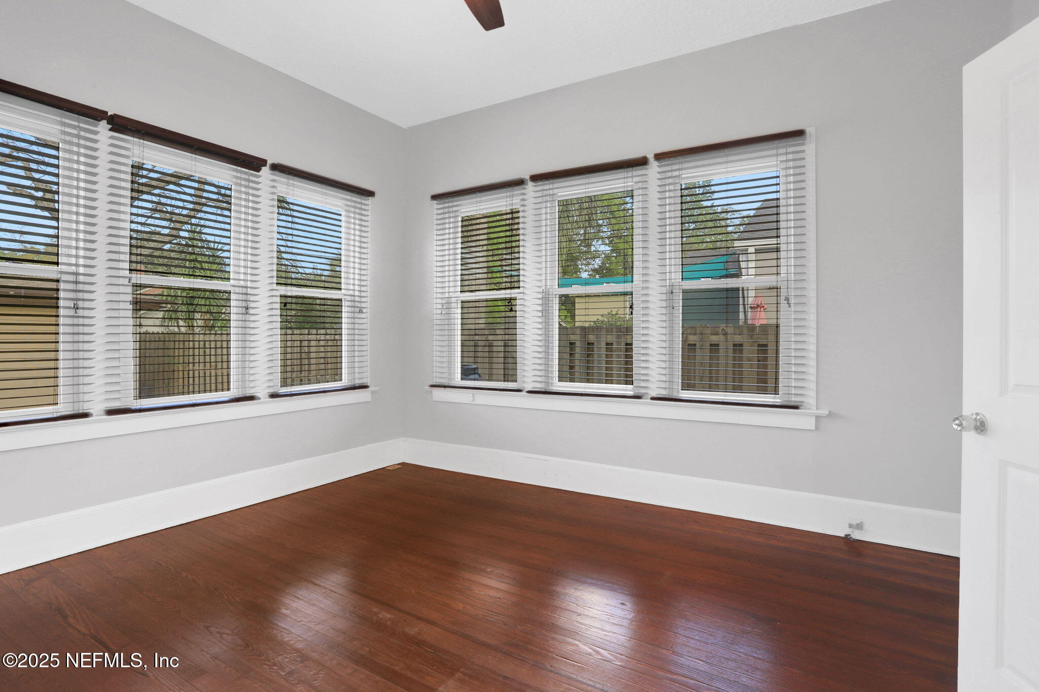 1393 Wolfe Street Jacksonville, FL 32205 - Photo 14 of 36 a view of an empty room with wooden floor and windows