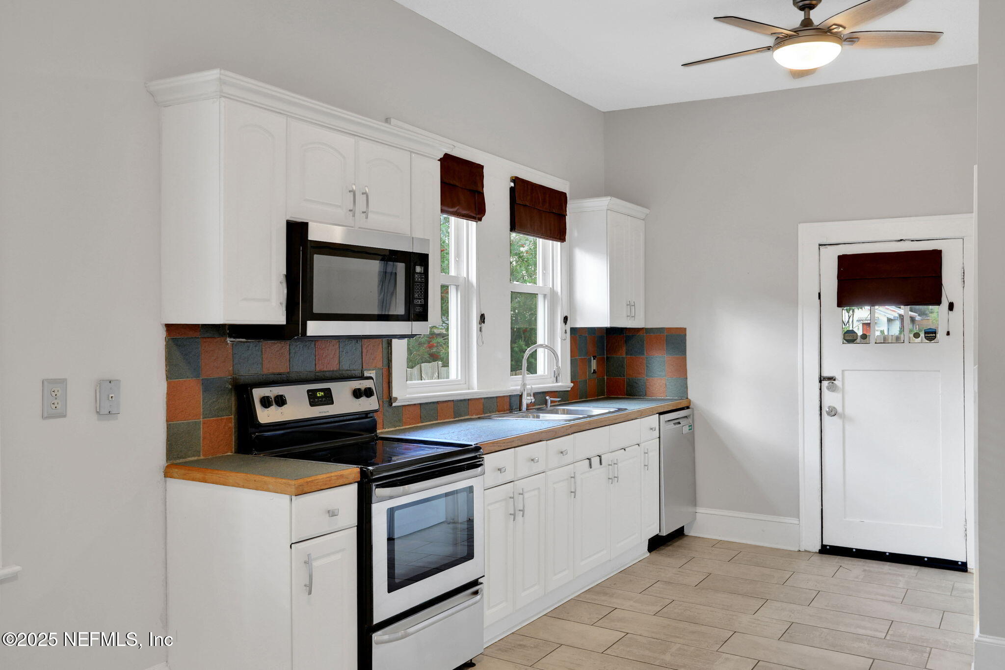 1393 Wolfe Street Jacksonville, FL 32205 - Photo 21 of 36 a kitchen with stainless steel appliances granite countertop a stove a sink and a microwave