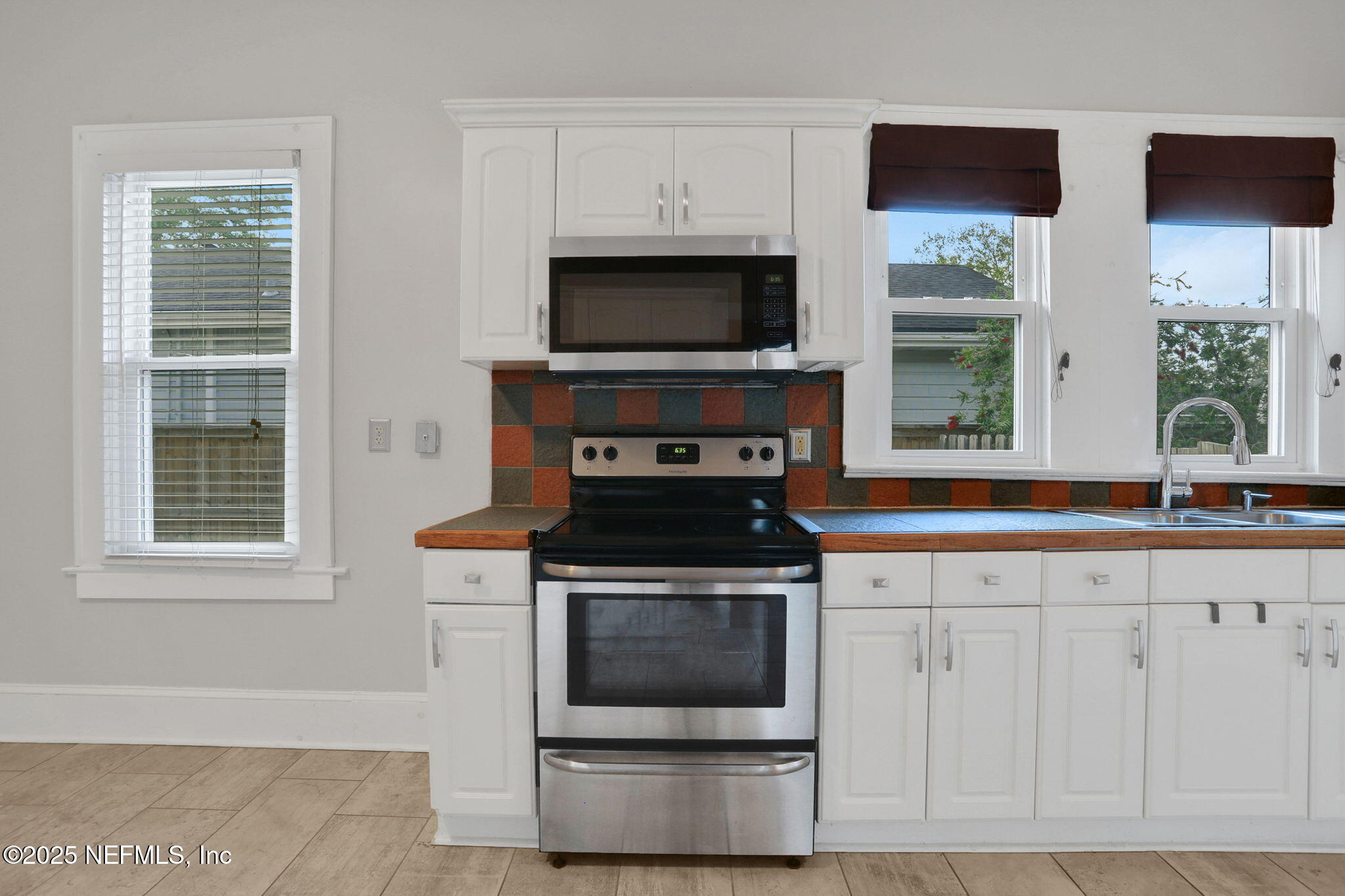1393 Wolfe Street Jacksonville, FL 32205 - Photo 23 of 36 a kitchen with stainless steel appliances a stove a microwave and a sink
