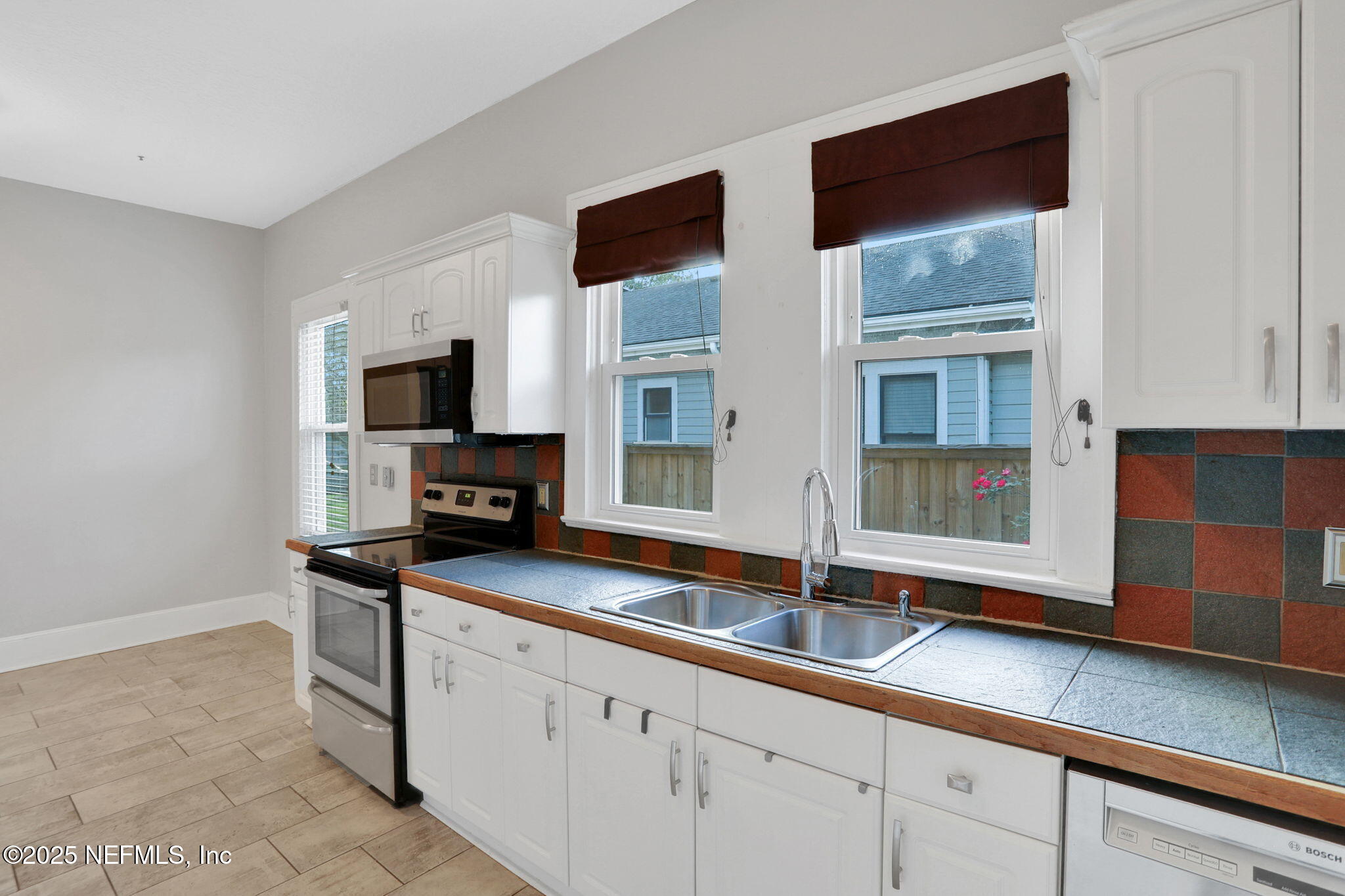 1393 Wolfe Street Jacksonville, FL 32205 - Photo 24 of 36 a kitchen with stainless steel appliances a sink and a microwave