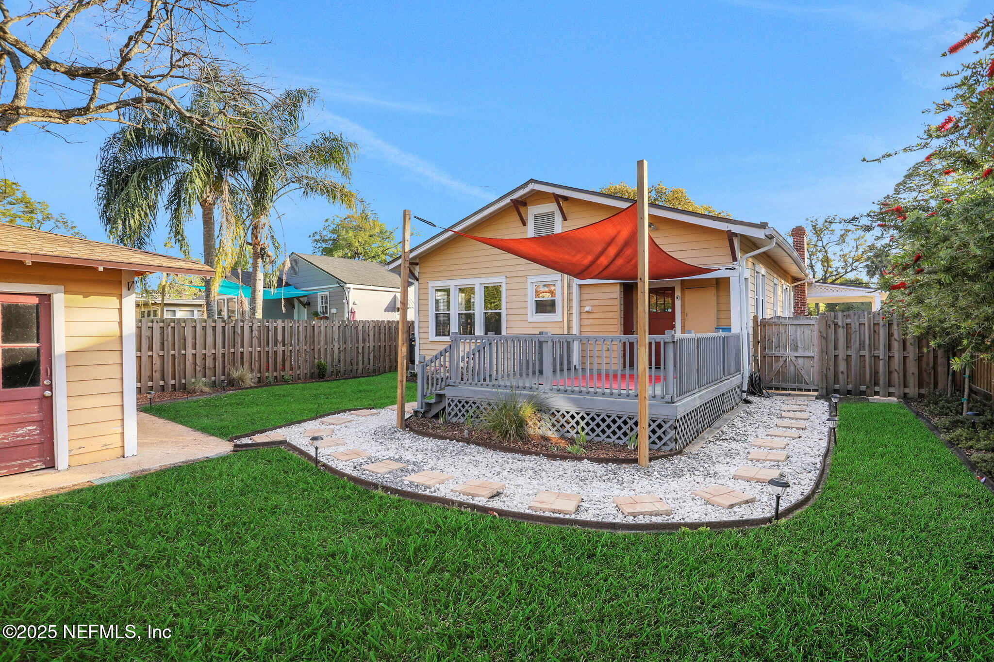 1393 Wolfe Street Jacksonville, FL 32205 - Photo 28 of 36 a view of a house with a small yard and wooden fence
