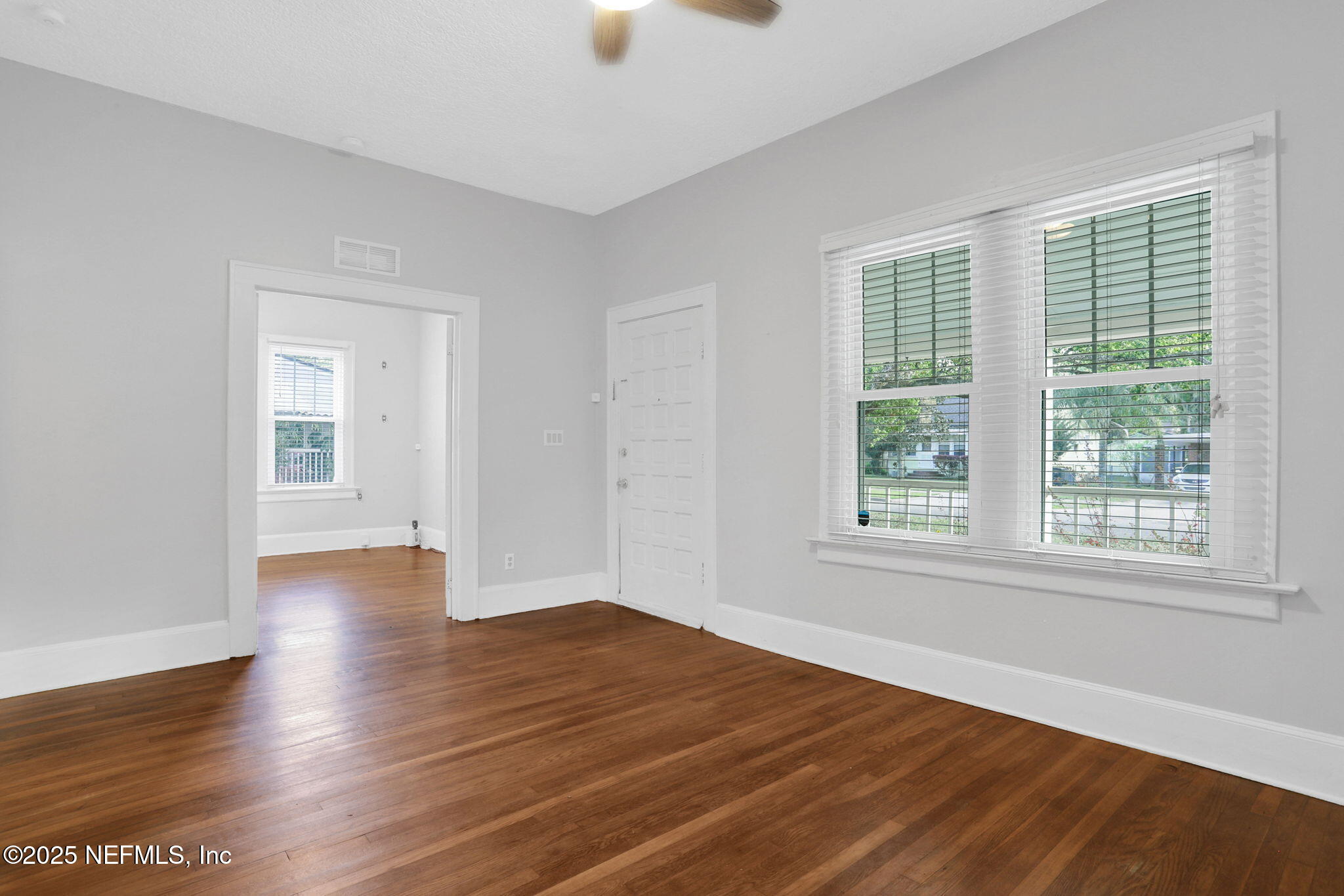 1393 Wolfe Street Jacksonville, FL 32205 - Photo 7 of 36 an empty room with wooden floor and windows