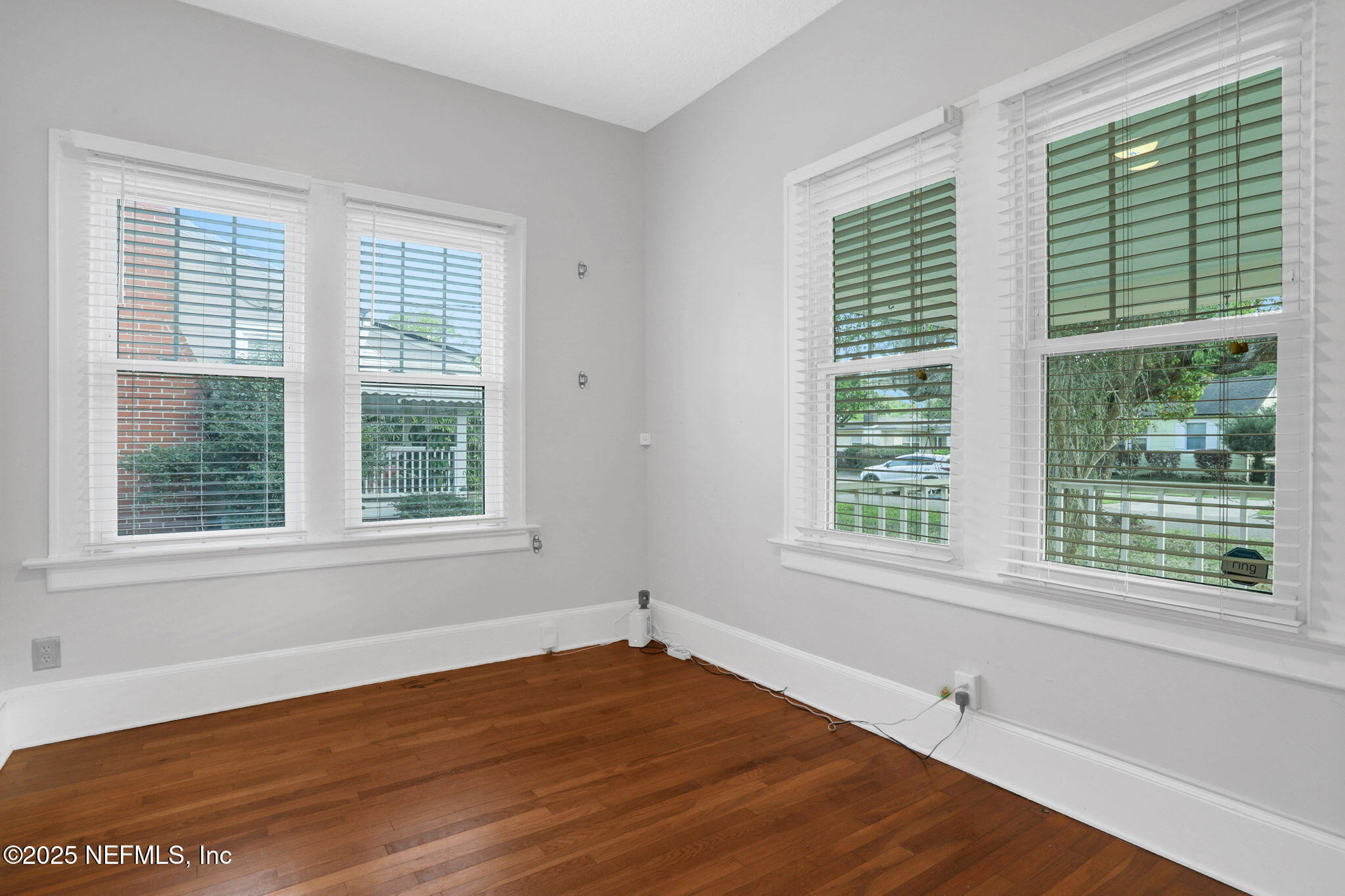 1393 Wolfe Street Jacksonville, FL 32205 - Photo 9 of 36 a view of an empty room with wooden floor and a window