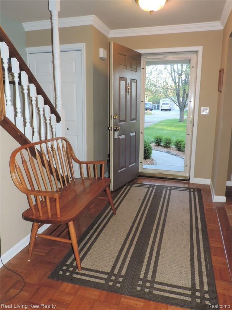1880 Ruby Avenue Rochester, MI 48309 - Photo 6 of 37 This foyer provides a warm welcome with the parquet floor and crown moldings.