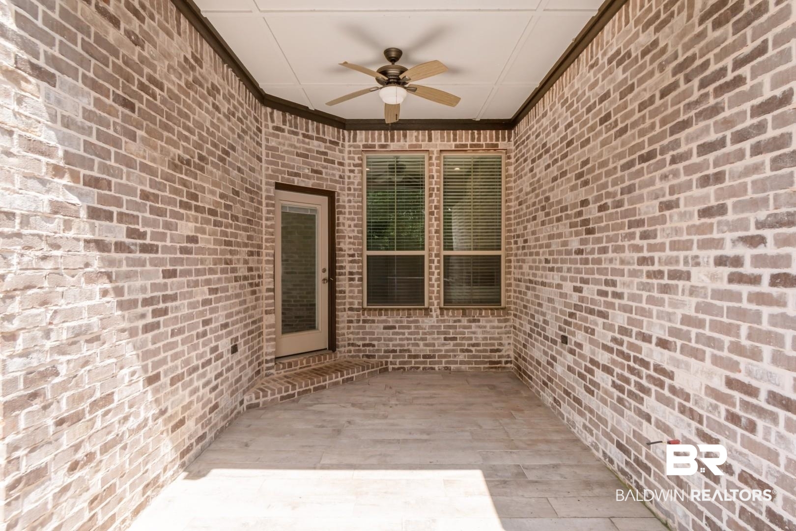 3528 Rue Royal Mobile, AL 36693 - Photo 47 of 53 Covered outdoor patio featuring brick walls, a ceiling fan, recessed lighting, and tile flooring