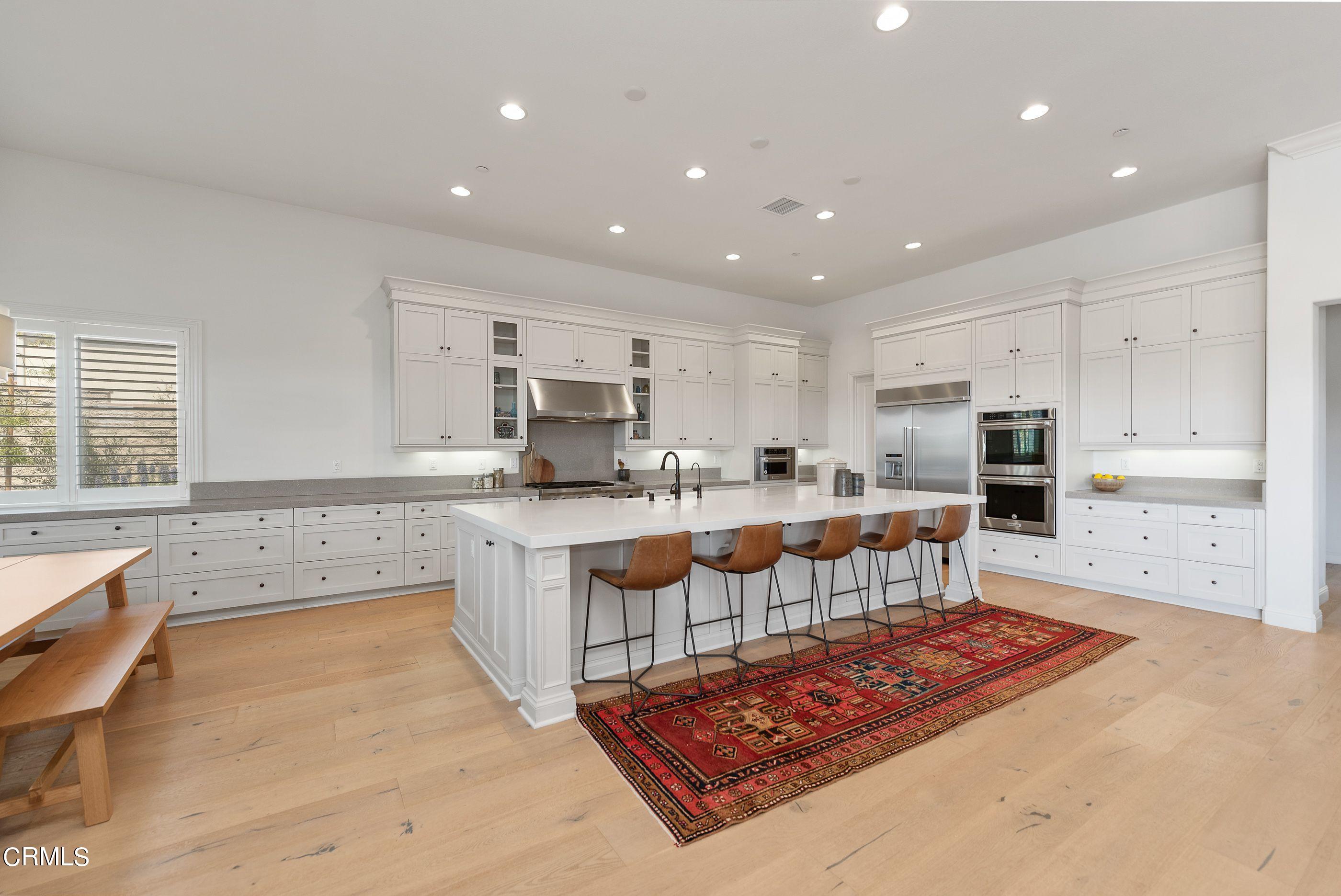 7355 Nicklaus Road Moorpark, CA 93021 - Photo 14 of 72 a large kitchen with kitchen island a sink a stove a center island and stainless steel appliances