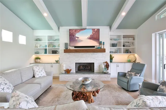 a kitchen with stainless steel appliances granite countertop a sink a stove and a wooden floors