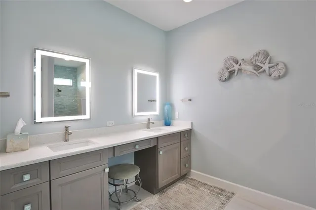 a bathroom with a granite countertop sink toilet a mirror and shower